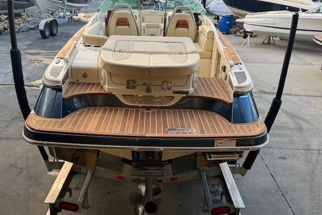 Slide: The Image of 2022 Chris-Craft Launch 25 GT boat on trailer, showcasing elegant design and spacious seating. - 7