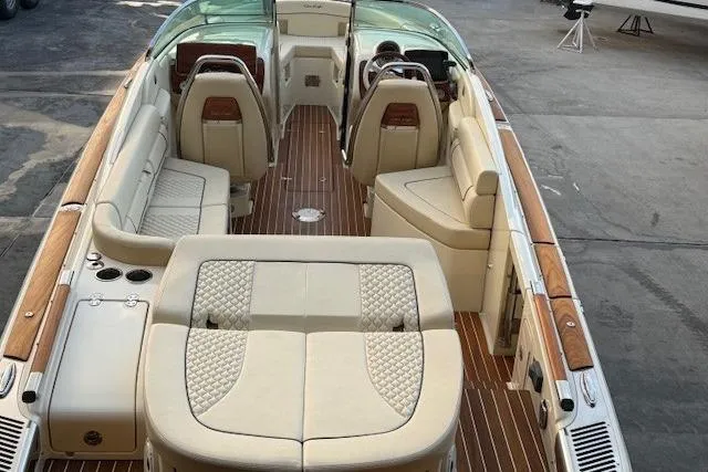 Slide: The Image of 2022 Chris-Craft Launch 25 GT boat interior with luxurious seating and wood accents. - 9