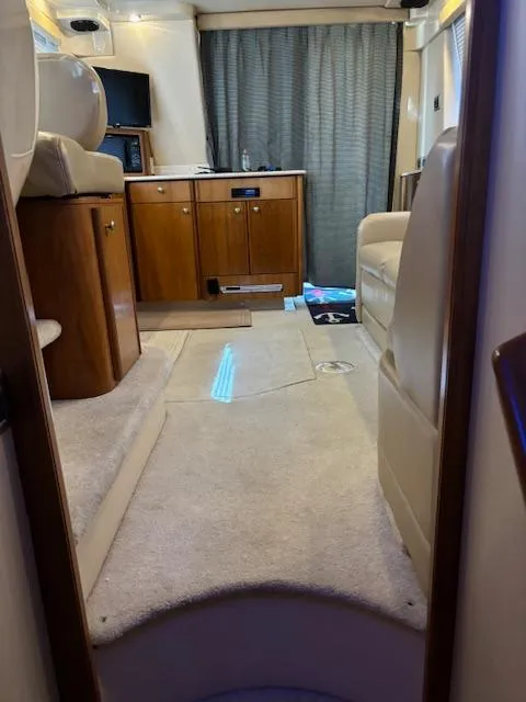 Slide: The Image of Interior of 2004 Meridian Sedan Bridge 341 yacht, featuring cozy seating and wooden cabinetry. - 20