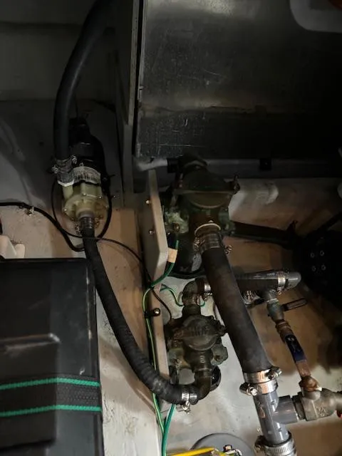 Slide: The Image of Engine compartment of 2004 Meridian Sedan Bridge 341 with visible hoses and components. - 34