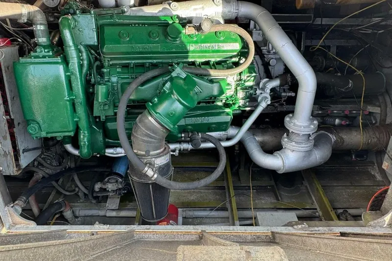 Slide: The Image of Green engine inside a 1964 custom commercial vehicle, showcasing intricate piping and components. - 6