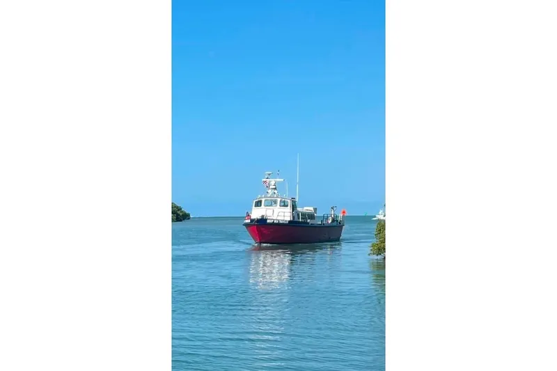 Slide: The Image of Vintage 1964 custom commercial boat on calm blue water under clear sky. - 7