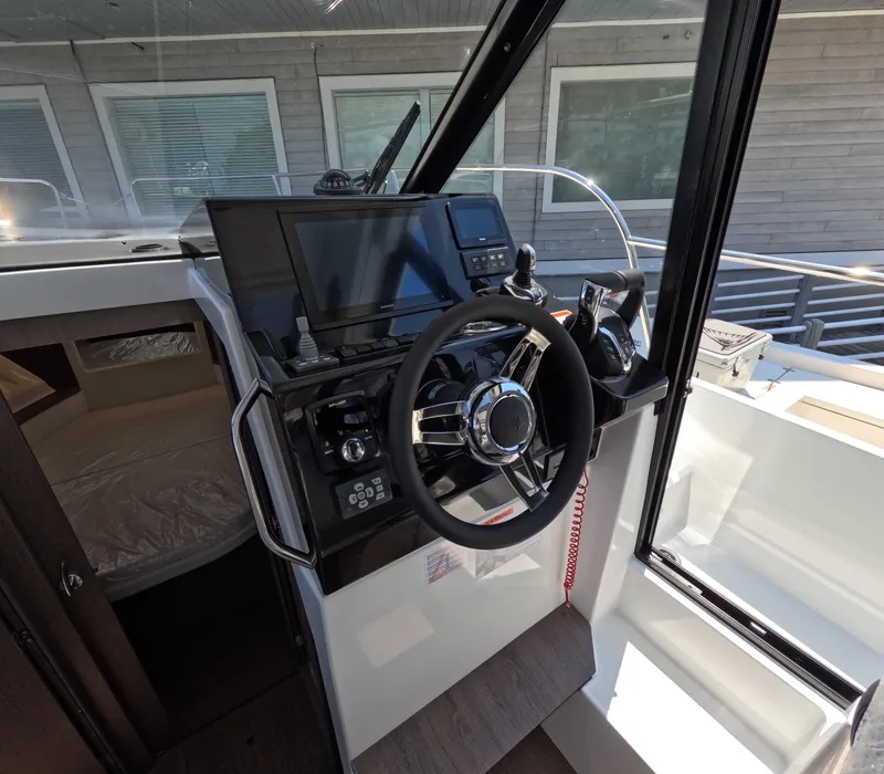 Slide: The Image of 2024 Jeanneau NC Weekender 895 Series 2 helm station with modern controls and navigation equipment. - 4