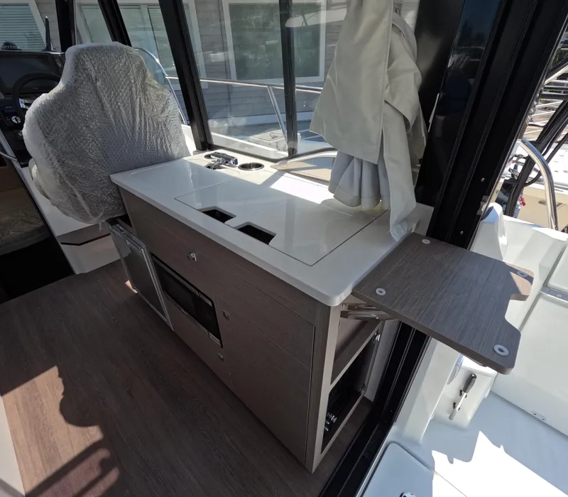Slide: The Image of Interior of 2024 Jeanneau NC Weekender 895 Series 2, featuring a compact kitchenette. - 5