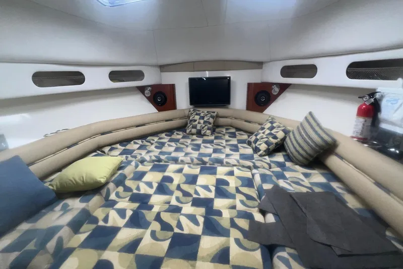 Slide: The Image of 2008 Pro-Line 32 Express cabin interior with patterned bedding and cushions. - 12
