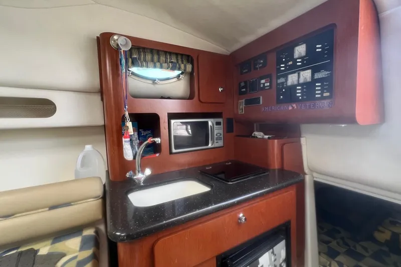 Slide: The Image of 2008 Pro-Line 32 Express boat interior with kitchenette, microwave, and control panel. - 14