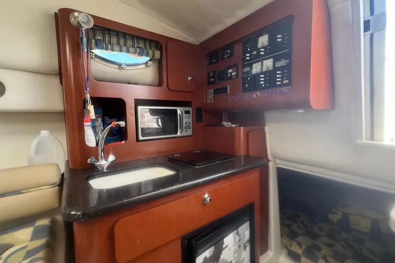 Slide: The Image of 2008 Pro-Line 32 Express cabin with kitchenette, microwave, and control panel. - 16