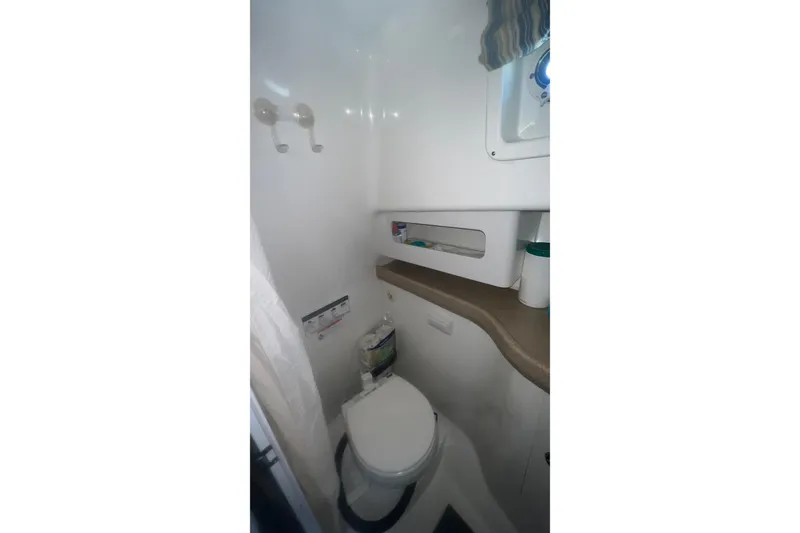 Slide: The Image of 2008 Pro-Line 32 Express boat bathroom with toilet and storage shelves. - 18