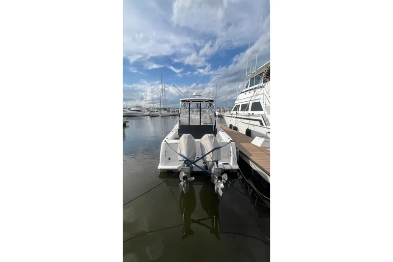 Slide: The Image of 2008 Pro-Line 32 Express boat docked at marina under cloudy sky. - 27