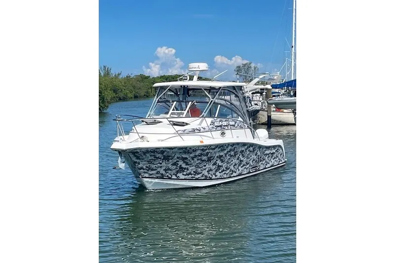 Slide: The Image of 2008 Pro-Line 32 Express boat with camouflage design on calm water. - 5