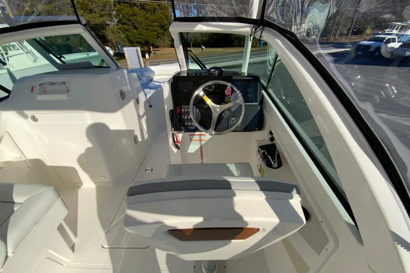 Slide: The Image of 2026 Pursuit DC 246 Dual Console boat interior with steering wheel and dashboard. - 12
