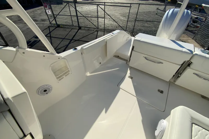 Slide: The Image of 2026 Pursuit DC 246 Dual Console boat interior with seating and storage compartments. - 15