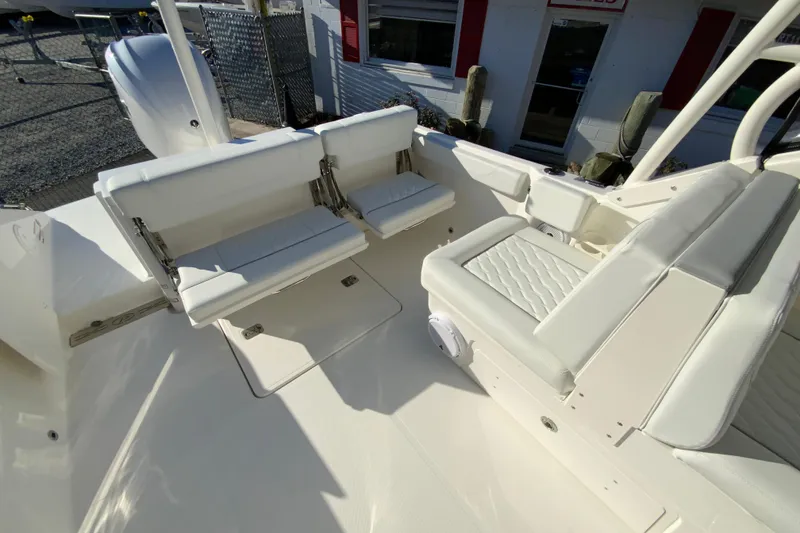 Slide: The Image of 2026 Pursuit DC 246 Dual Console boat interior with white seating and modern design. - 16