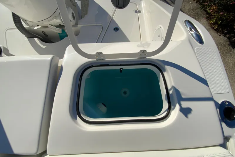 Slide: The Image of 2026 Pursuit DC 246 Dual Console boat with open storage compartment. - 19