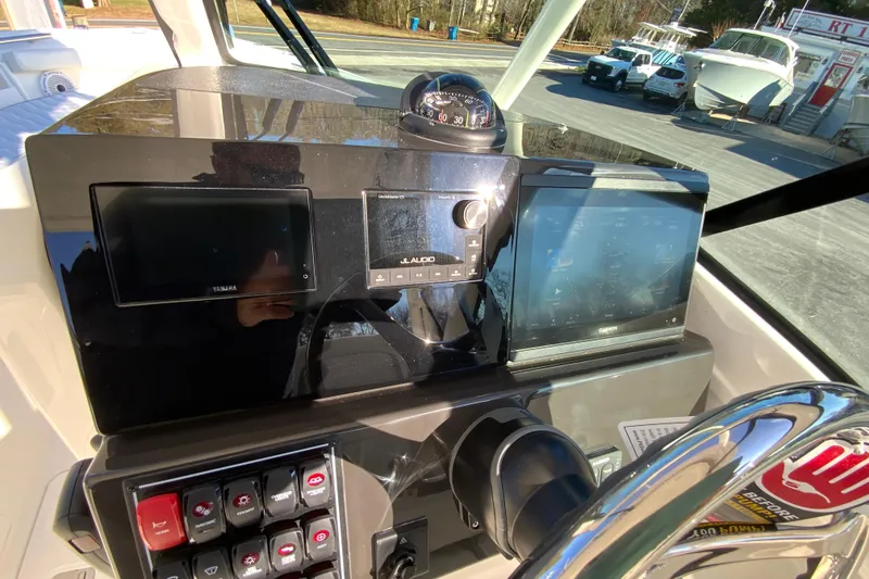 Slide: The Image of 2026 Pursuit DC 246 Dual Console dashboard with navigation and control systems. - 22