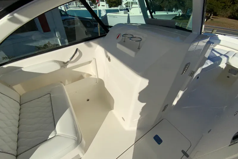 Slide: The Image of 2026 Pursuit DC 246 Dual Console interior with white seating and sleek design. - 24