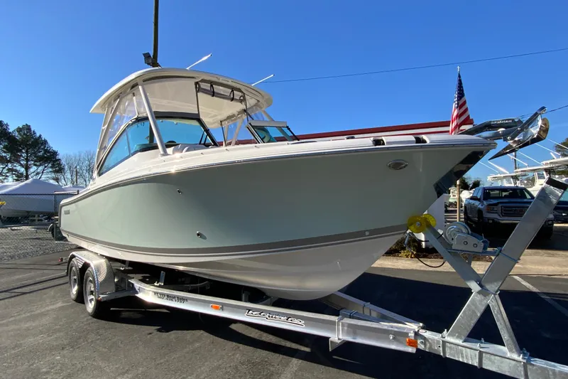 Slide: The Image of 2026 Pursuit DC 246 Dual Console boat on trailer, displayed outdoors. - 3