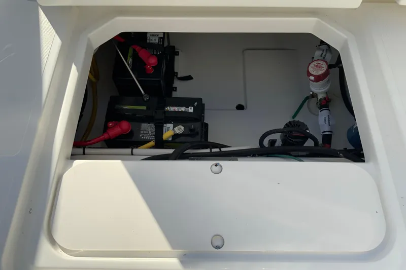 Slide: The Image of 2026 Pursuit DC 246 Dual Console battery compartment with wiring and components. - 33