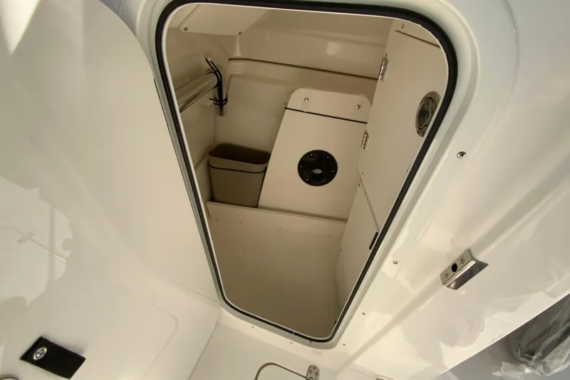 Slide: The Image of 2026 Pursuit DC 246 Dual Console interior storage compartment with clean, white finish. - 39