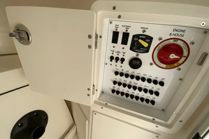 Slide: The Image of Electrical control panel of 2026 Pursuit DC 246 Dual Console boat, featuring switches and gauges. - 40