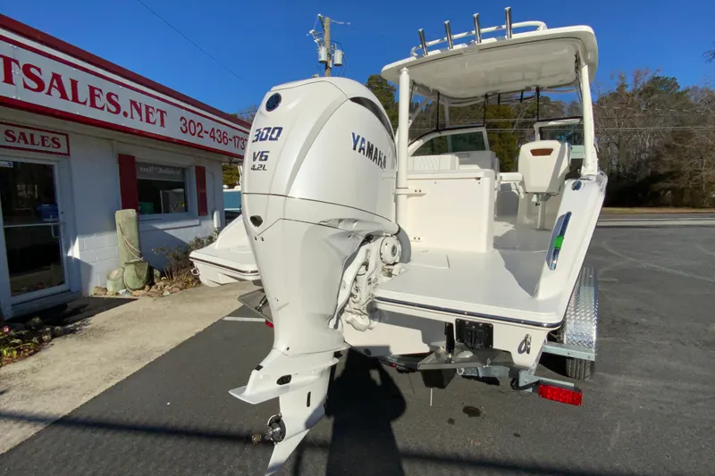 Slide: The Image of 2026 Pursuit DC 246 Dual Console boat with Yamaha 300 V6 engine at dealership. - 9