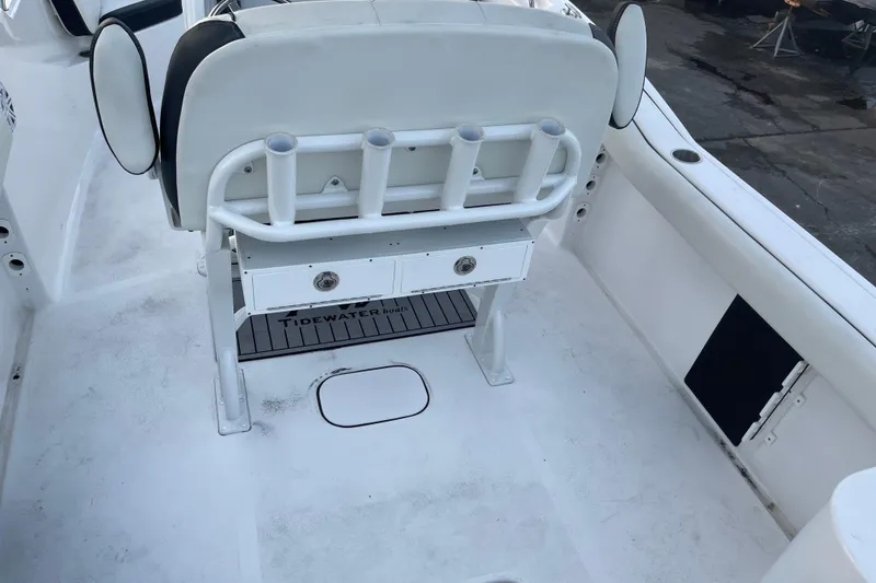 Slide: The Image of 2024 Tidewater 232 CC Adventure boat interior with rod holders and storage drawers. - 3