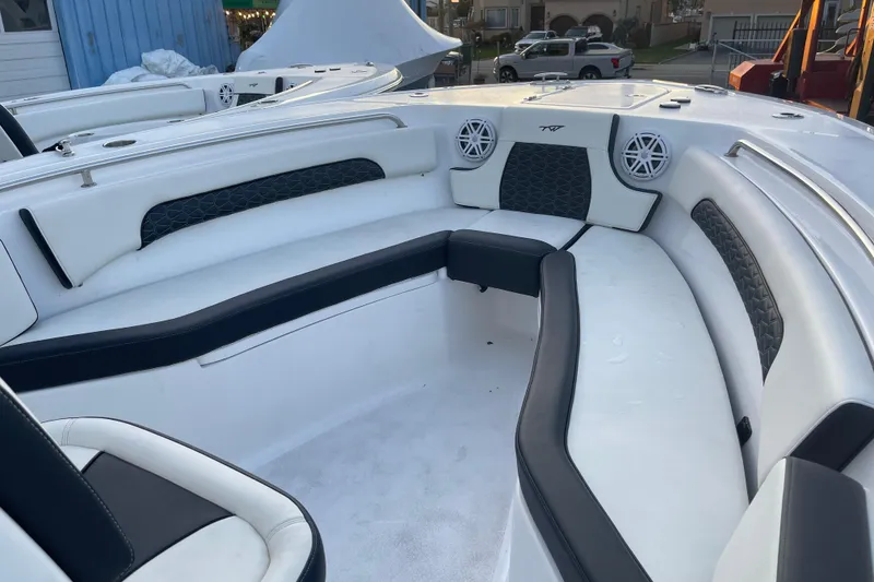 Slide: The Image of 2024 Tidewater 232 CC Adventure boat interior with cushioned seating and speakers. - 5
