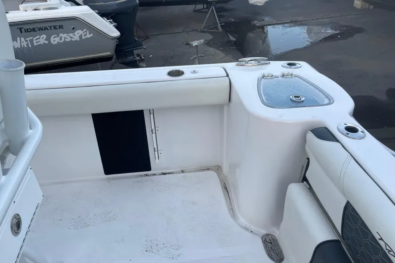 Slide: The Image of 2024 Tidewater 232 CC Adventure boat interior with seating and storage compartments. - 9