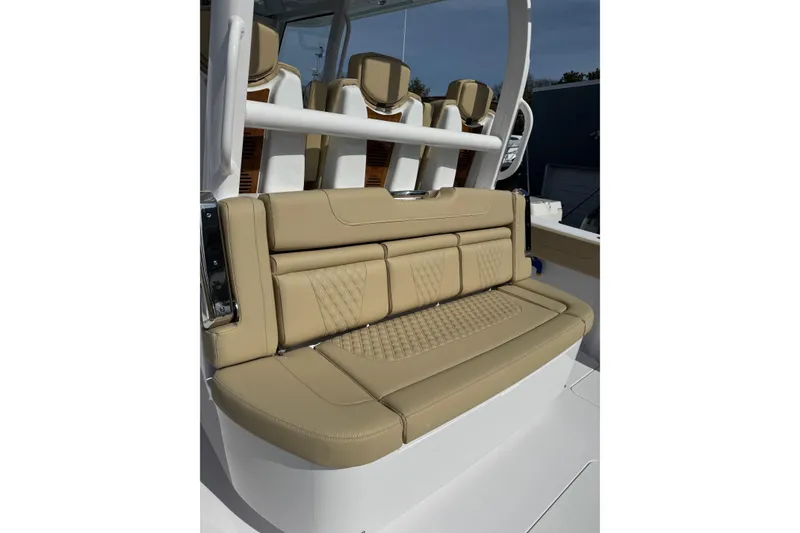 Slide: The Image of Luxurious seating on 2026 Phenom 37 Center Console boat, featuring tan leather upholstery. - 11