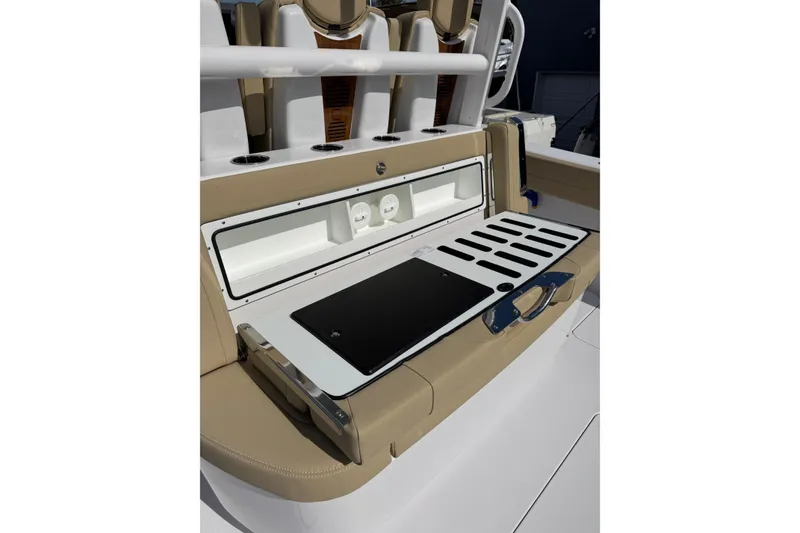 Slide: The Image of 2026 Phenom 37 Center Console boat interior with beige seating and storage compartments. - 12