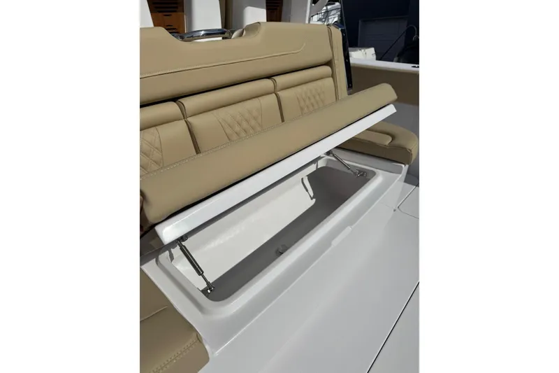 Slide: The Image of 2026 Phenom 37 Center Console boat with tan cushioned seating and storage compartment. - 13