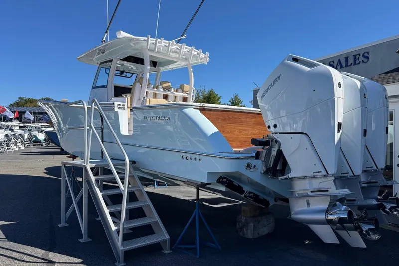 Slide: The Image of Phenom 37 boat from 2026 with Mercury engines on display lot. - 2