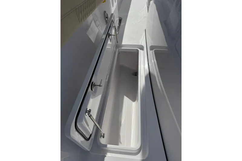 Slide: The Image of Open storage compartment on a 2026 Phenom 37 Center Console boat. - 21