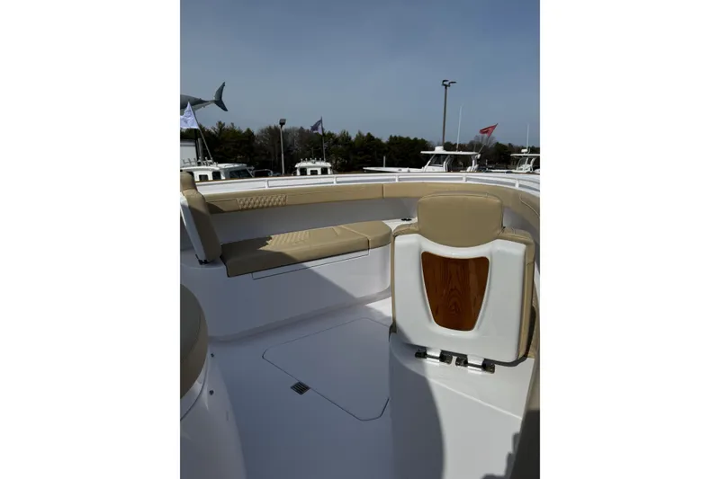 Slide: The Image of 2026 Phenom 37 Center Console boat interior with beige seating and wood accents. - 22