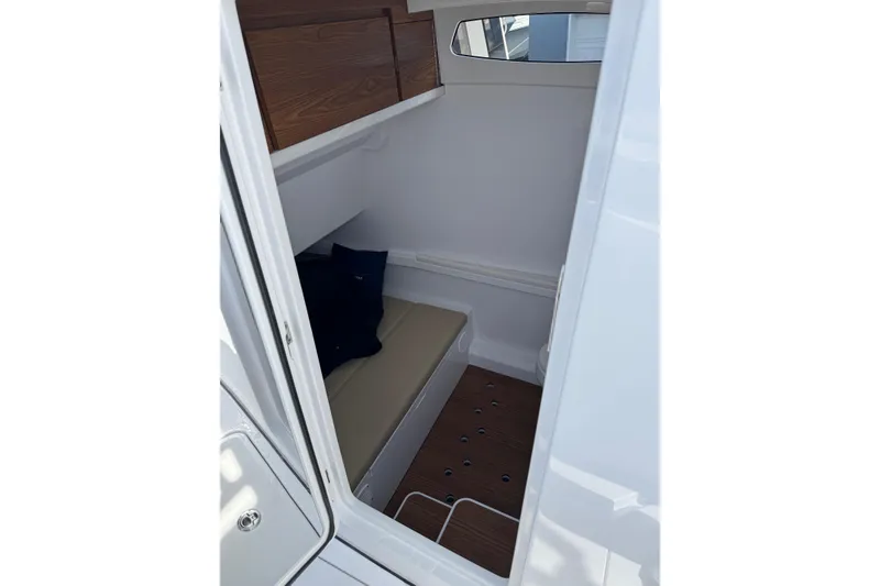 Slide: The Image of Interior cabin of 2026 Phenom 37 Center Console boat, featuring seating and wood accents. - 26