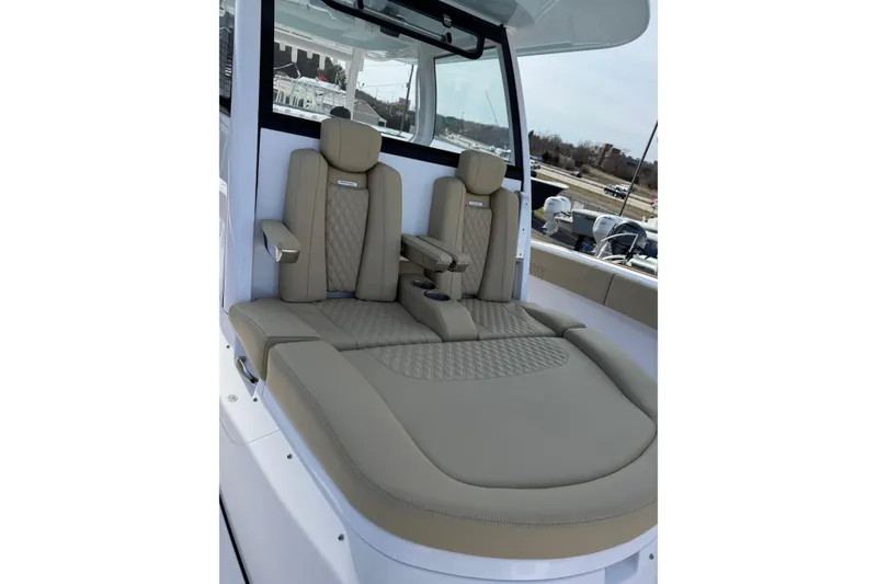 Slide: The Image of Luxurious seating on 2026 Phenom 37 Center Console boat, featuring beige leather upholstery. - 29
