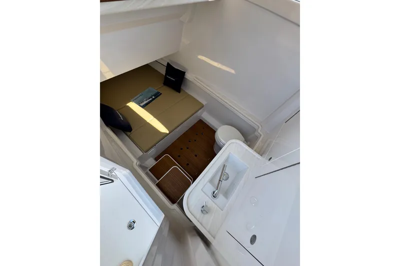 Slide: The Image of Interior of 2026 Phenom 37 boat featuring a compact cabin with bed and sink. - 5