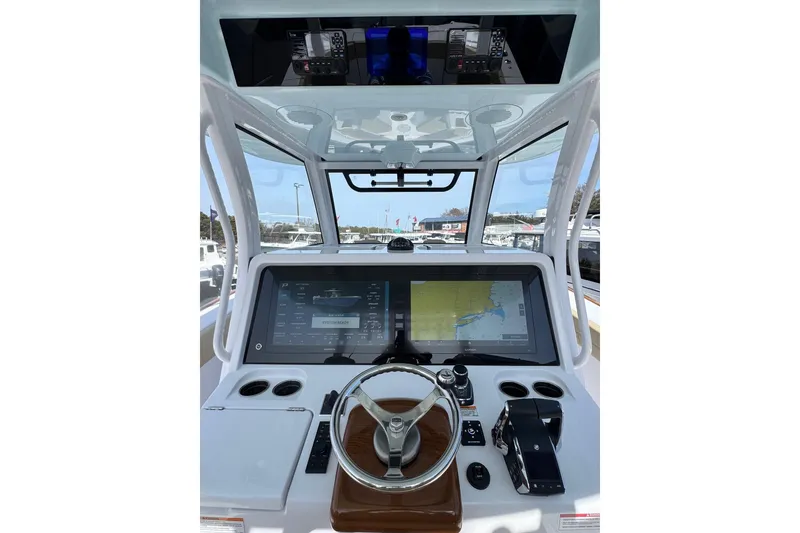 Slide: The Image of Interior view of 2026 Phenom 37 Center Console boat dashboard with navigation screens. - 8