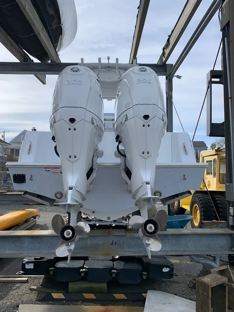 Slide: The Image of 2026 Contender 25 T boat with dual outboard engines on a lift. - 3