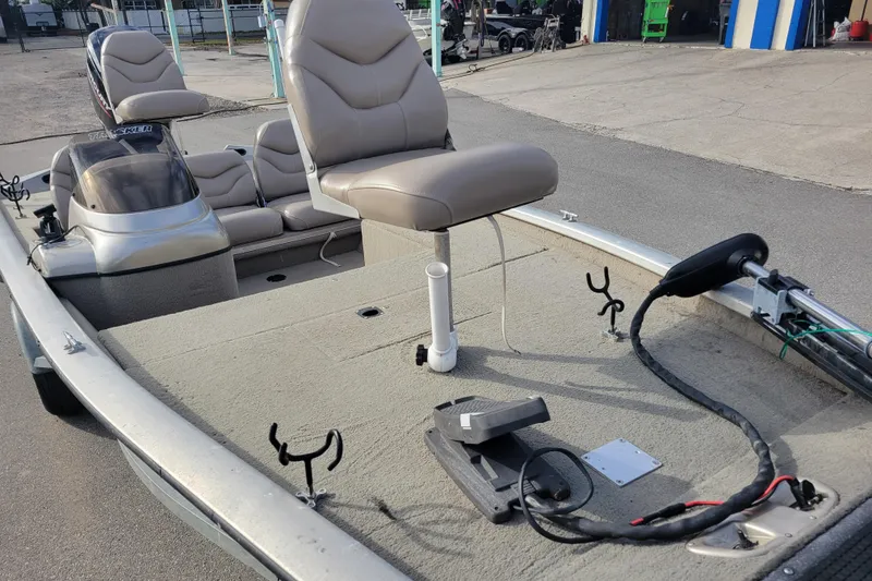 Slide: The Image of 2002 Tracker Pro Team 175 boat with seating and fishing rod holders. - 11