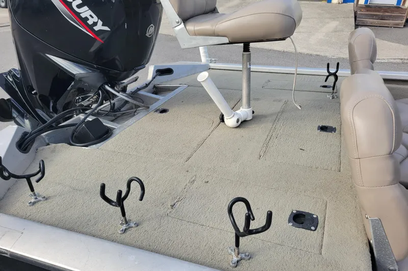 Slide: The Image of 2002 Tracker Pro Team 175 boat deck with Mercury motor and fishing rod holders. - 14