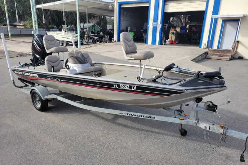 Slide: The Image of 2002 Tracker Pro Team 175 boat on a trailer, parked outside a garage. - 3