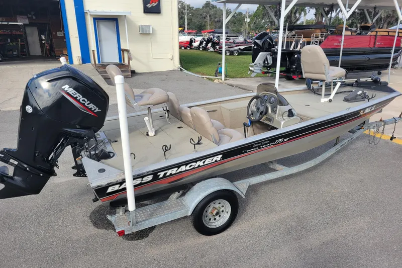 Slide: The Image of 2002 Tracker Pro Team 175 boat with Mercury engine on trailer, parked outside. - 4