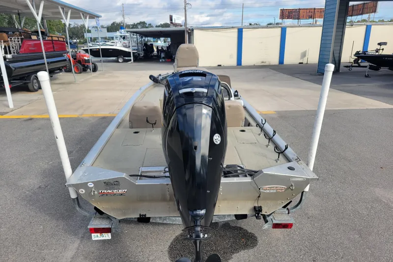 Slide: The Image of 2002 Tracker Pro Team 175 boat with Mercury outboard motor, parked at a marina. - 5
