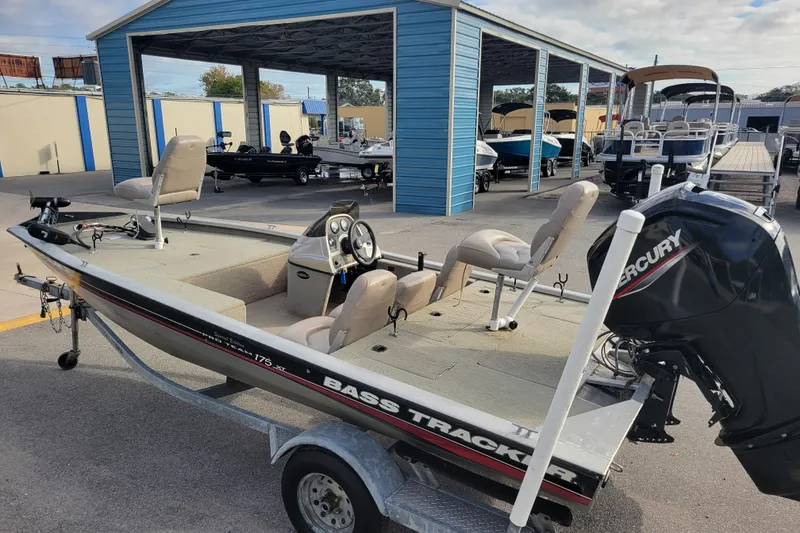 Slide: The Image of 2002 Tracker Pro Team 175 boat with Mercury engine in a marina setting. - 6