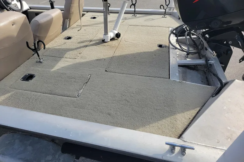 Slide: The Image of 2002 Tracker Pro Team 175 boat interior with carpeted deck and motor. - 7