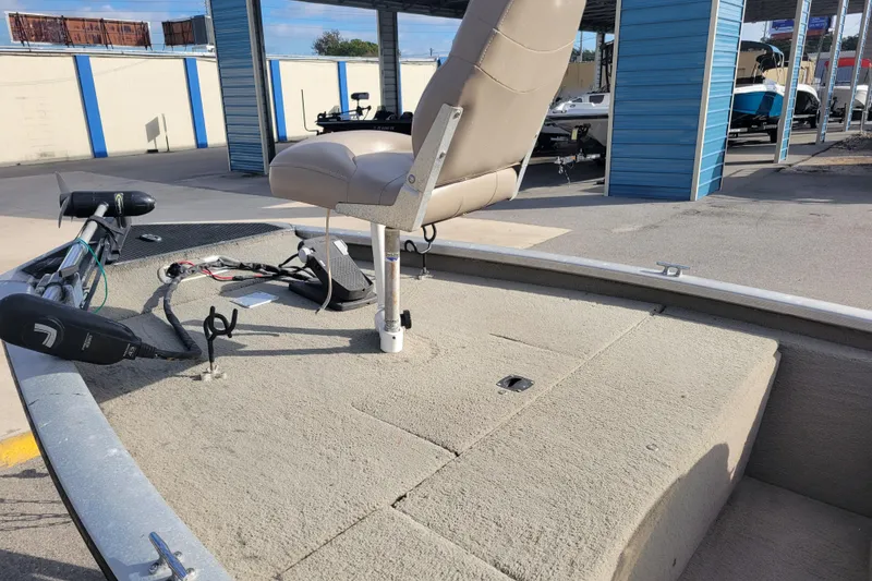 Slide: The Image of 2002 Tracker Pro Team 175 boat with beige seating and trolling motor in storage area. - 9