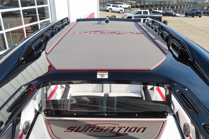 Slide: The Image of 2026 Sunsation 32 CCX boat with sleek design and modern features, docked near a marina. - 17