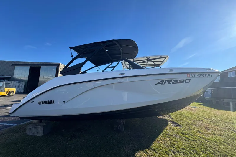 Slide: The Image of 2023 Yamaha Boats AR220 on display outdoors under clear blue sky. - 6