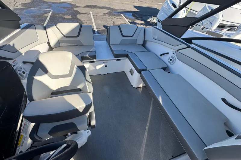 Slide: The Image of 2023 Yamaha Boats AR220 interior with spacious seating and modern design. - 9